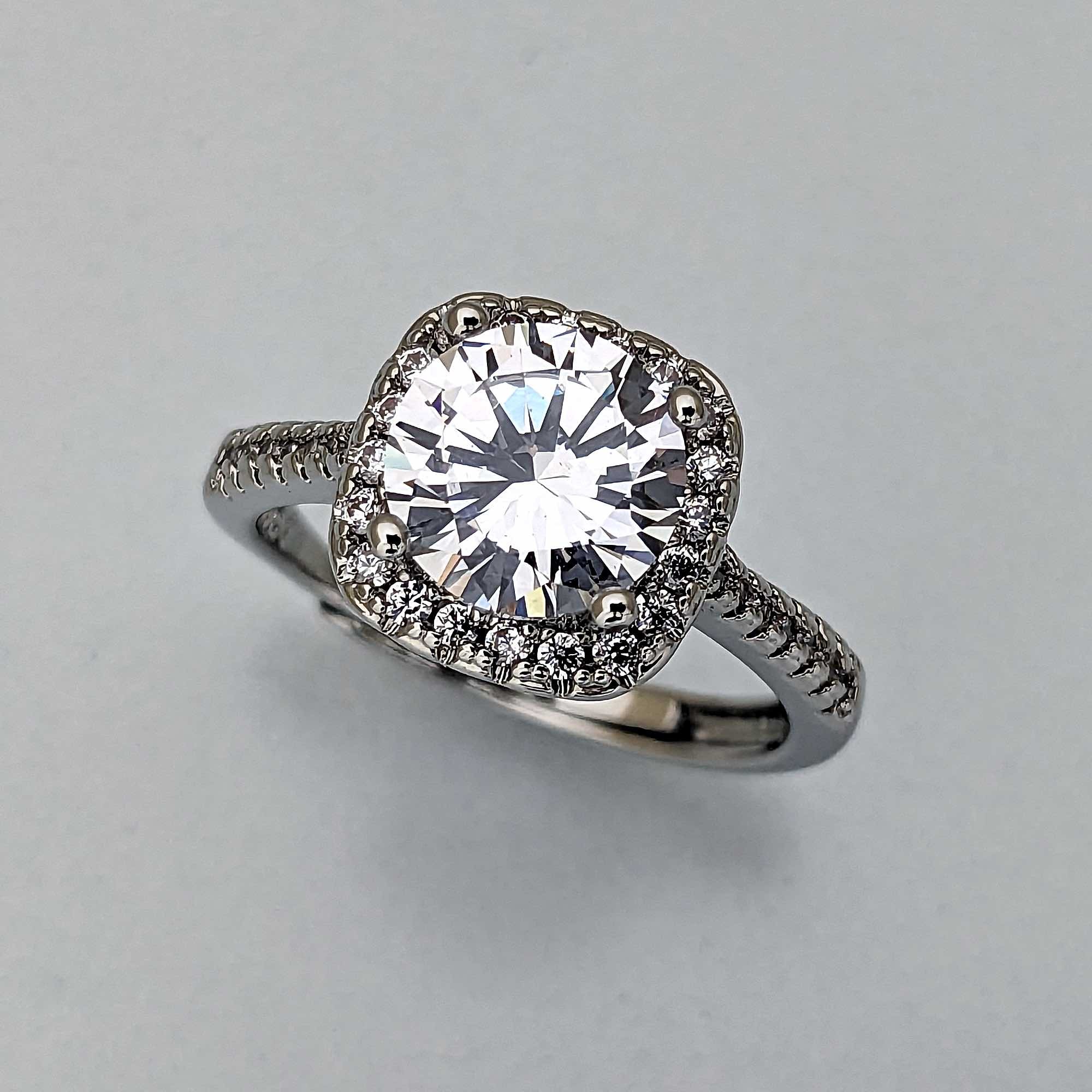 ２カラットの輝くダイヤモンドを囲むダイヤモンドで太陽が輝くような婚約指輪